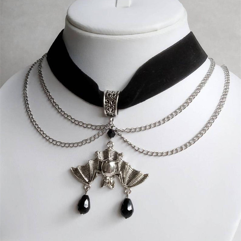 A woman is wearing Black Rose Sword Earrings with bats on it from the brand Maramalive™.