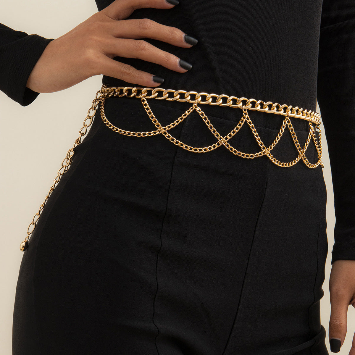 A woman wearing a black jumpsuit with a Maramalive™ Geometric Aluminum Body Chain belt.