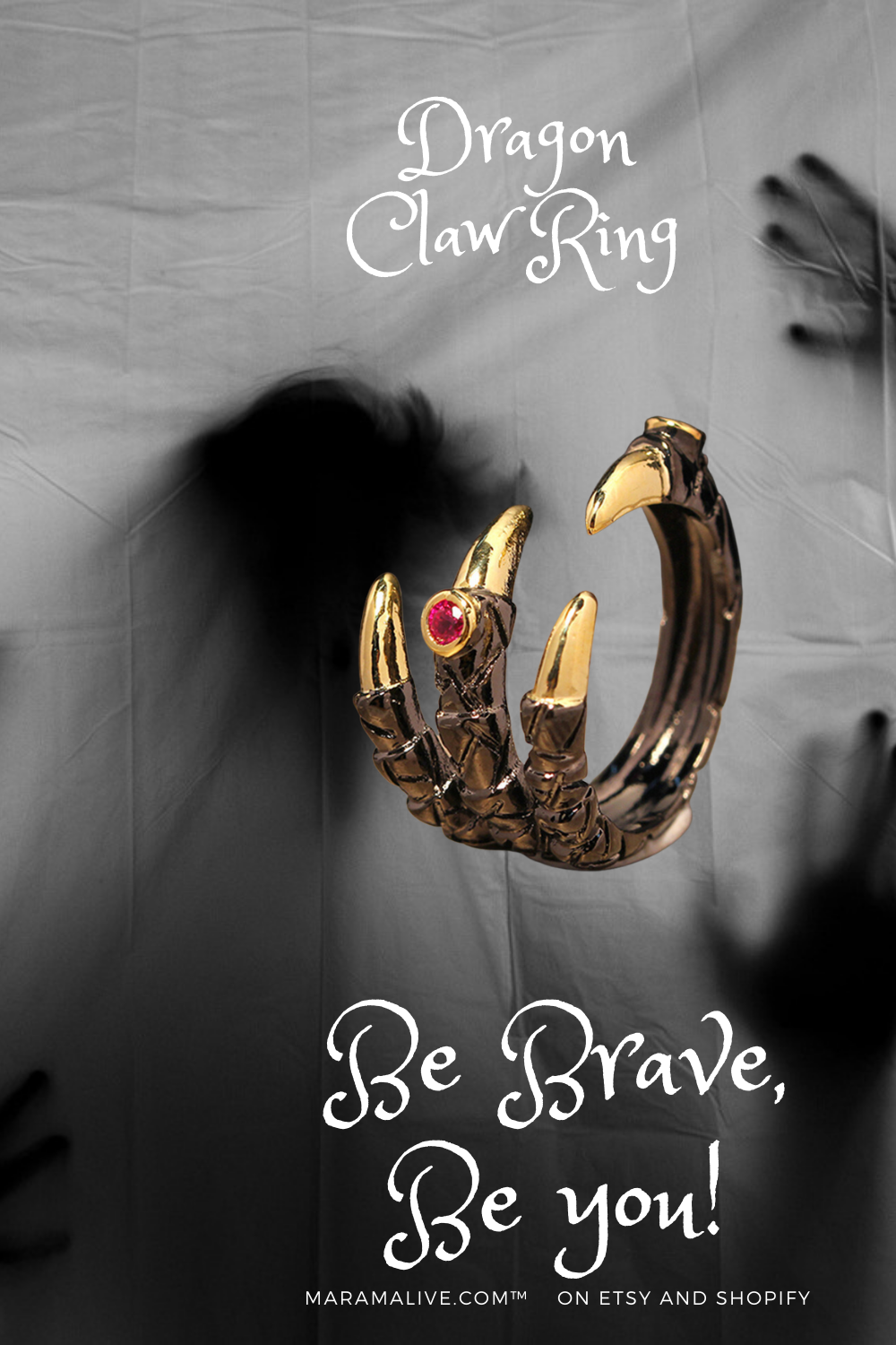 A Dragon Claw Ring from Maramalive™ with claws and a pink stone.