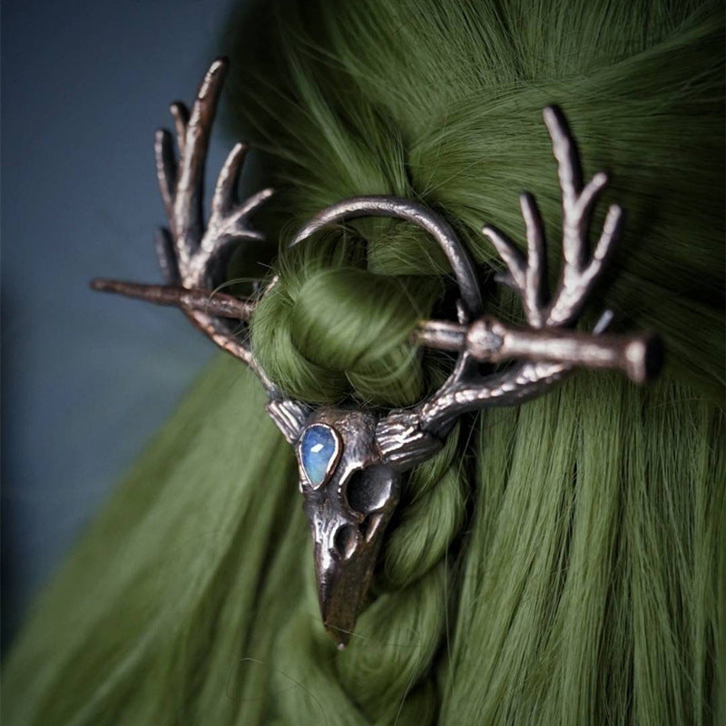 A spooky woman with a Twilight Talon - Gothic Retro Crow Skeleton Moonlight Stone Deer Horn Women's Hairpin by Maramalive™ on her head.