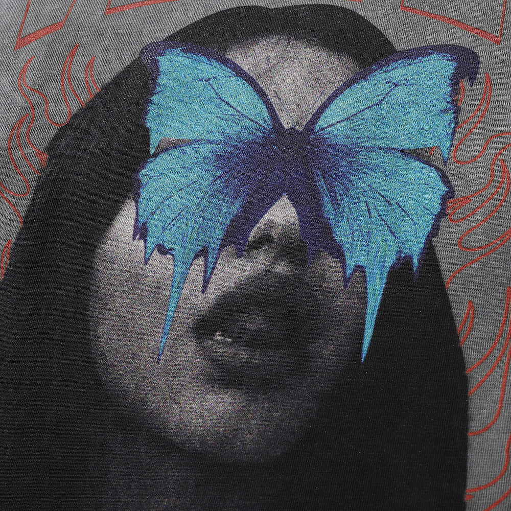 A close-up of a person with long hair, wearing a Maramalive™ Men's Dark Character Old Washed Long-sleeved T-shirt, with a blue butterfly image partially obscuring their face, set against a dark background with red wavy lines.