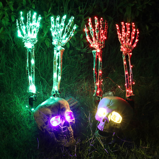 Three Maramalive™ Halloween Decorative Skeleton Hand Halloween Garden Decoration Props LED Light-emitting Ghost Hand Skull Hand Plug Lights with a waterproof battery cover placed in the grass.