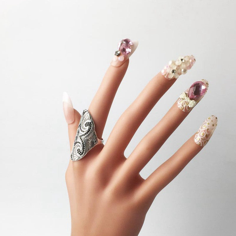 A mannequin with pink and white nails and a Maori Pattern Ethnic Style Ring Sterling Silver Index Finger from Maramalive™.