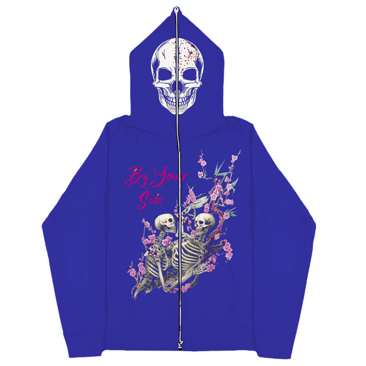 Blue hoodie with a skull design on the hood and graphic of two skeletons amidst flowers on the front. Made from soft cotton, the text "By Your Side" is printed above the graphic. This piece is known as the Gothic Couple Harajuku Black Sweatshirt Zipper Sweater by Maramalive™.