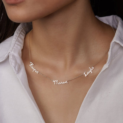 A woman wearing a Maramalive™ Personalized Multiple Name Nameplate Pendant Necklace You Choose with three names on it.
