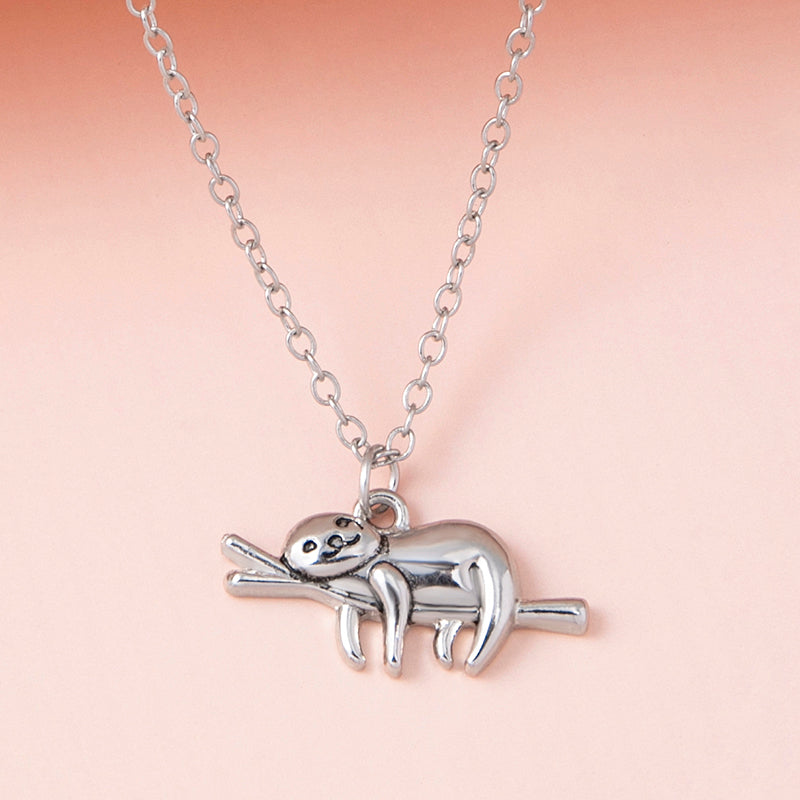 A Maramalive™ Silver Color Slow Down Be Happy Slider Sloth Pendant Necklace with a sloth on a branch.
