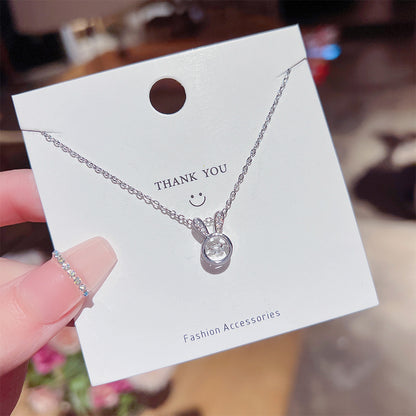 A person holding a card with a Maramalive™ Bunny Necklace Simple All-match Titanium Steel Clavicle Chain on it.