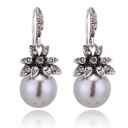 A pair of Maramalive™ gray pearl earrings on a white background.