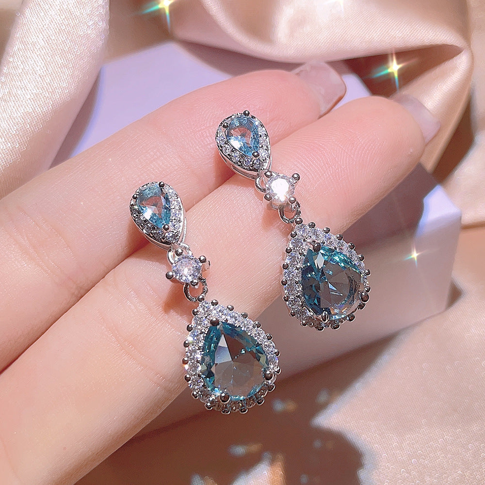 A Women's Inlaid Blue Zircon Ring Earrings Necklace set on a satin from Maramalive™.