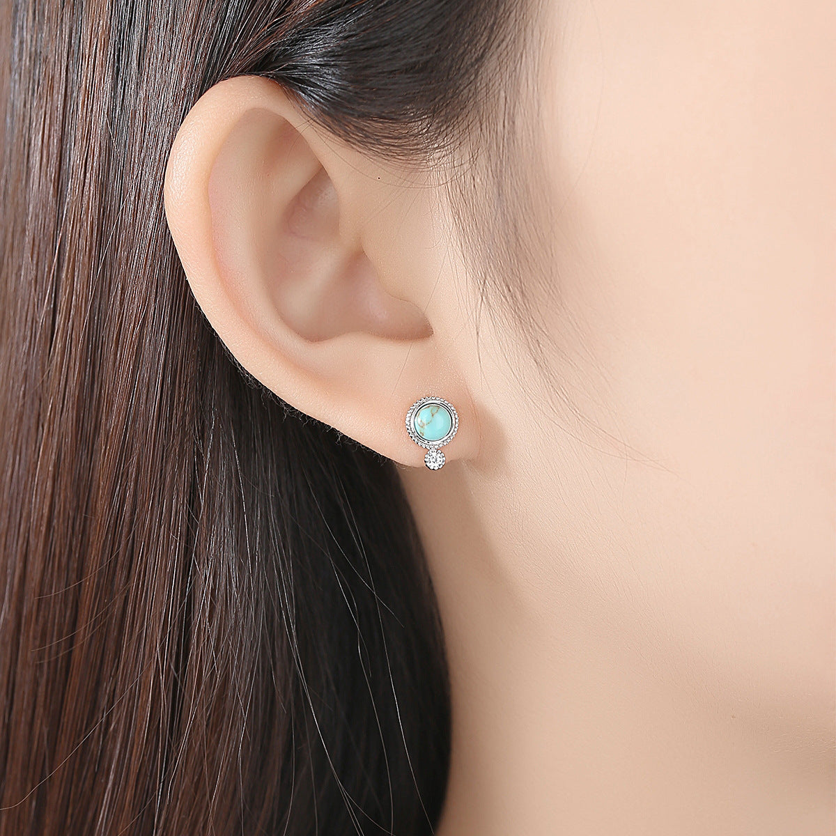 A woman's ear with Maramalive™ Small Turquoise Stud Earrings - Retro Fashion.