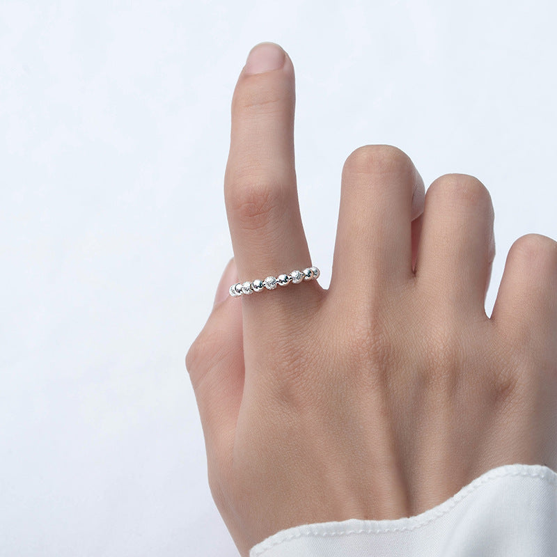 A woman's hand with a Maramalive™ Women's Stylish And Simple Personality Sterling Silver Anxiety Ring on it.