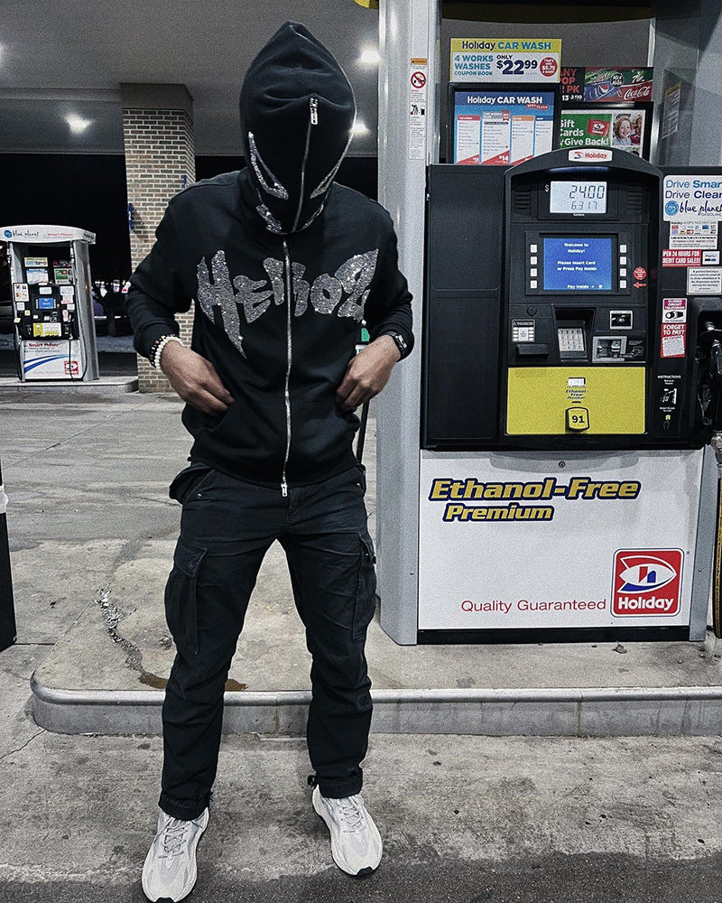 A man with a super attitude in a unisex gothic dark Diamante-Studded Hoodie Sweatshirt for Edgy Style by Maramalive™ standing next to a gas pump.