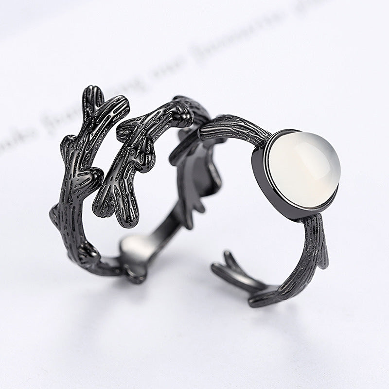 A black Make a Bold Statement with the Fashion Spike Rose Couple Ring from Maramalive™ with a white stone on it.