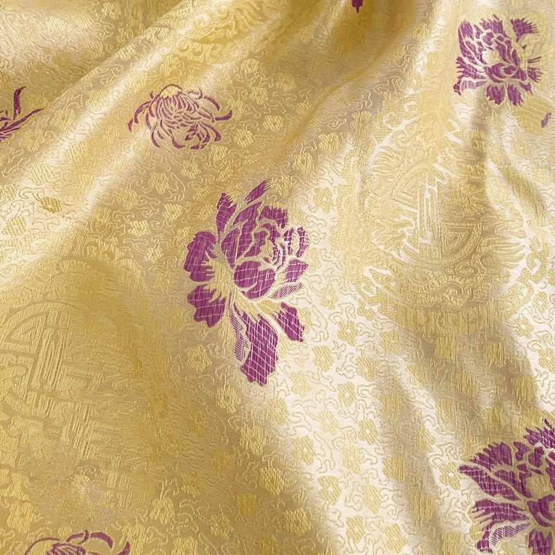 A Maramalive™ yellow and purple fabric with flowers on it.