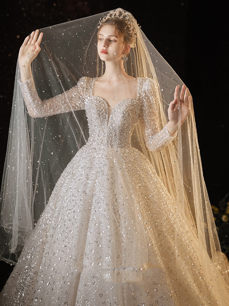 A woman in a Maramalive™ Women's Super Heavy Industrial Wedding Dress with long sleeves and sequins.