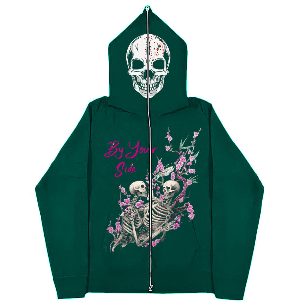 A green Gothic Zipper Sweater: The Perfect Gothic Top Multi-colors by Maramalive™ with a skull design on the hood. The back features two skeletons among flowers with the text "By Your Side" in pink. This gothic-style piece is perfect for adding an edgy twist to your wardrobe.