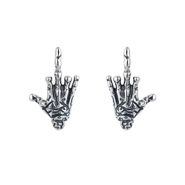 A pair of Exaggerated Gothic Dark Skull Hand Stud Earrings in Sterling Silver by Maramalive™ on a white background.