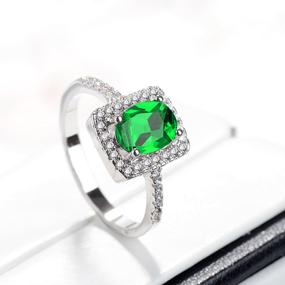 An emerald stone ring jewelry on a white background by Maramalive™.