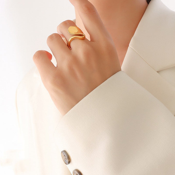 A woman wearing a white jacket and gold rings, including Fashion Banquet Accessories Geometric Unique No Color Fading Special-shaped Glossy Rings from Maramalive™.