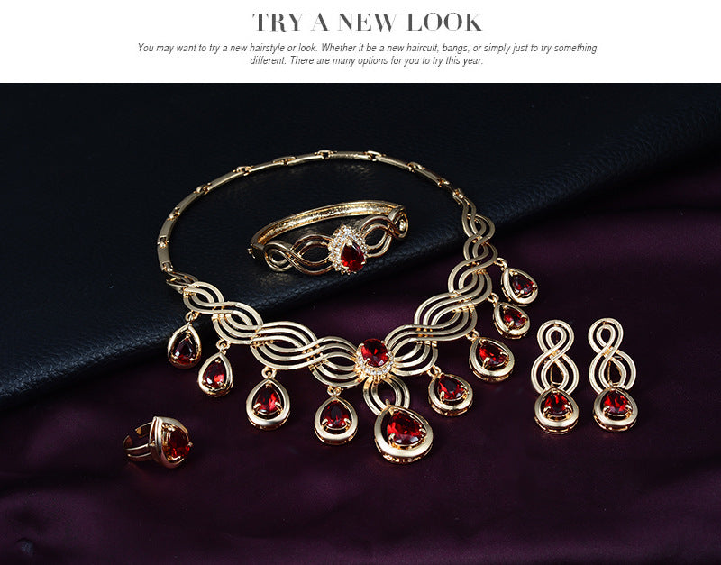 A Maramalive™ gold jewelry set with red stones.