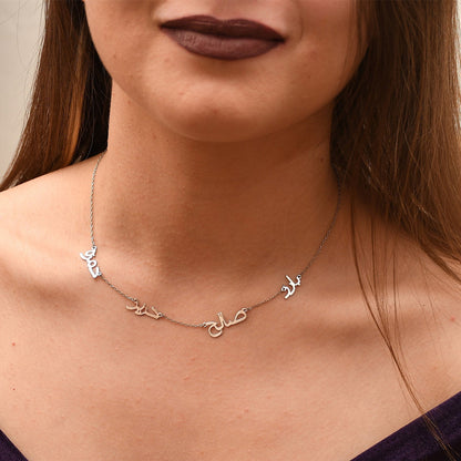 A woman wearing a Maramalive™ Personalized Multiple Name Nameplate Pendant Necklace You Choose with three names on it.