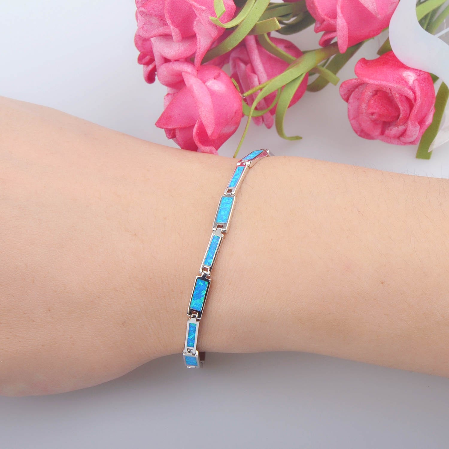 A woman's wrist with a Maramalive™ Opal Gems embedded in Chain Bracelet for Someone Special.
