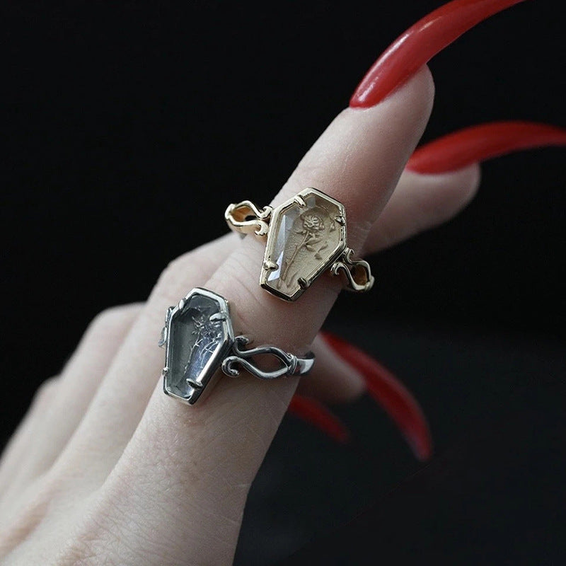 A woman's hand with two CJ Halloween Gothic Rose Coffin Rings on it.