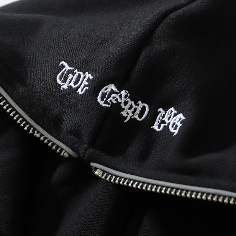 Black fabric with a metal zipper and white embroidered text in a Gothic font, reading "THE GOOD FEELING". This Maramalive™ FallWinter College BF Wind Hooded Cardigan Sweatshirt National Tide Printed Loose Sports Casual Hoodie is perfect for cooler days and adds a touch of edgy elegance to your wardrobe.