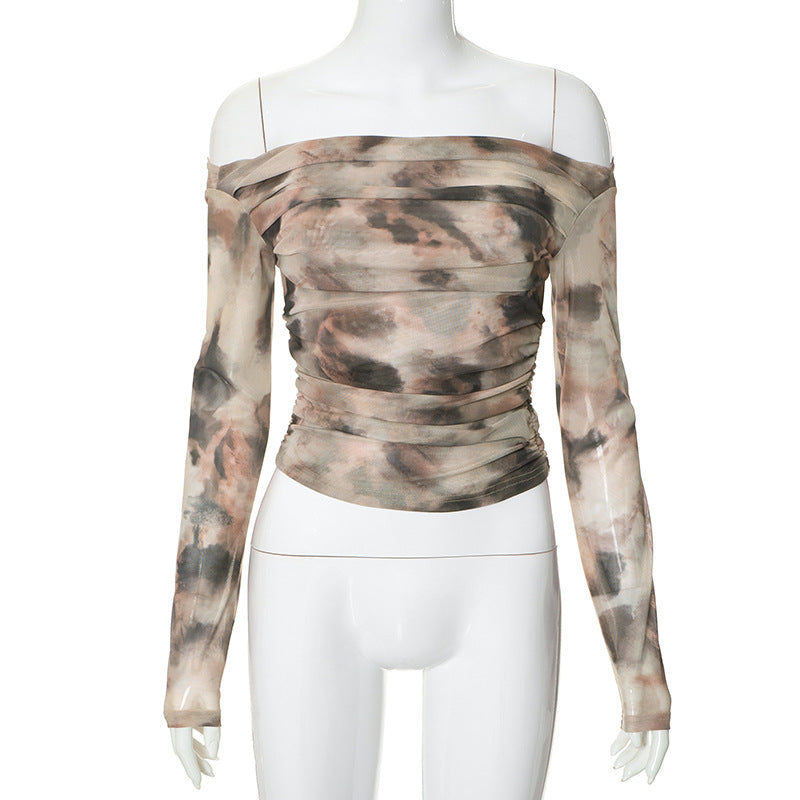 A mannequin displays a Maramalive™ Printed Off-neck Long Sleeve Backless Pleated Top with a ruched design and an abstract watercolor pattern in beige, black, and pink hues. The stylish piece is crafted from soft polyester, offering both comfort and elegance for any occasion.