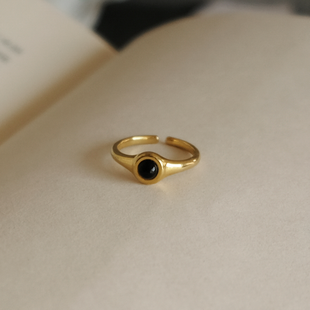 A woman wearing a Maramalive™ European And American All-match Pearl Black Onyx Ring with an evil eye on it.
