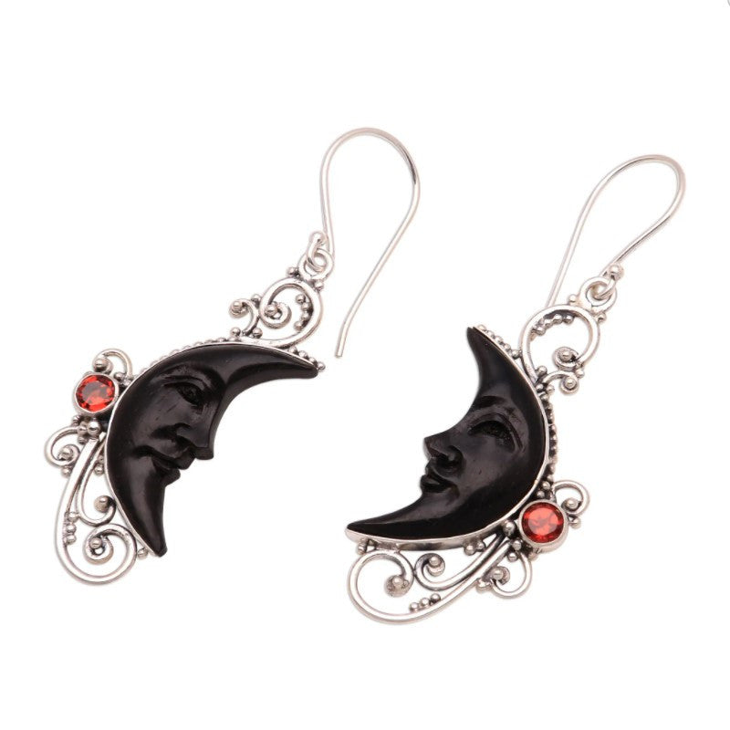 A pair of Hollowed Fashion Carved Gem Black Moon Earrings from Maramalive™ with a crescent moon and red garnets.