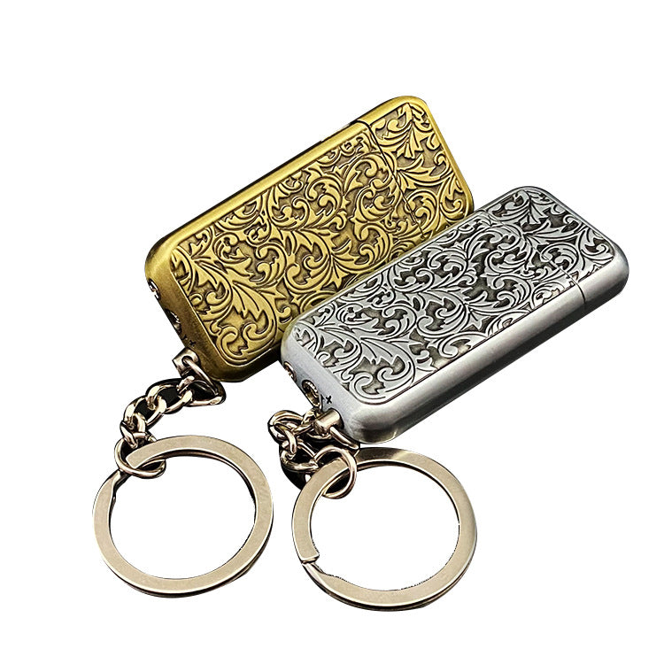 A gold and silver Buckle Butane Gas Inflatable Mini Antique Grinding Wheel Flame Lighter with a chain on it by Maramalive™.