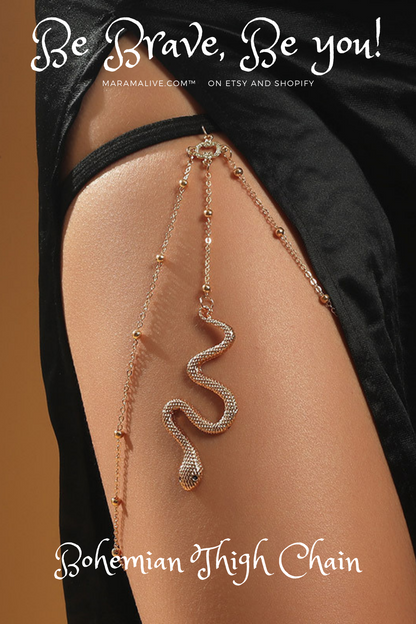 A woman is wearing a Maramalive™ Bohemian Boho Gold Color Metal Beaded Chain Thigh Chain For Women Big Snake Pendants Leg Chain Body Jewelry Beach Style Gift on her thigh.