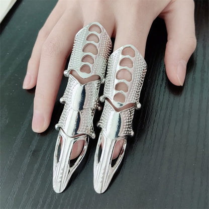 A woman is holding a silver Exaggerated Personality Knuckle Nail Rings for Women by Maramalive™.