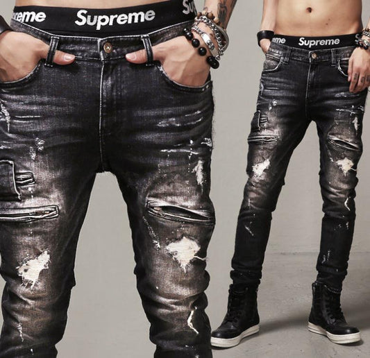 A pair of Maramalive™ MCCKLE Hi-Street Mens Ripped Biker Jeans Black Slim Fit Motorcycle Jeans Men Vintage Distressed Denim Jeans Trousers Pants with a supreme logo on them.