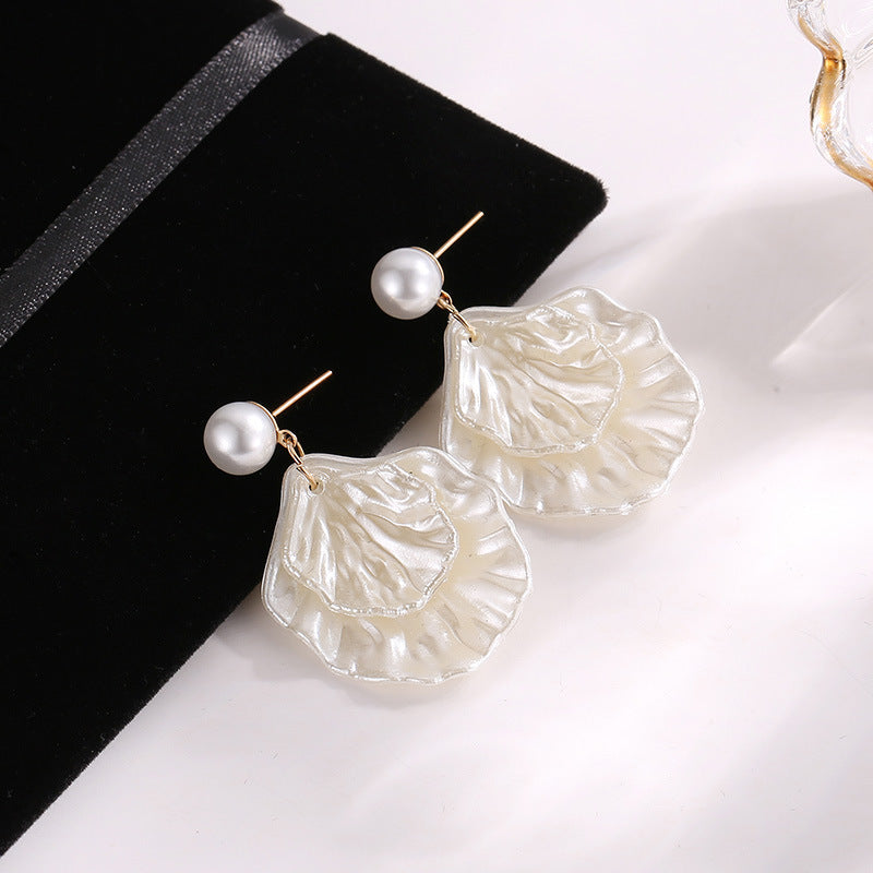 A pair of Maramalive™ Pearl Shell Earrings for Women on a black background.