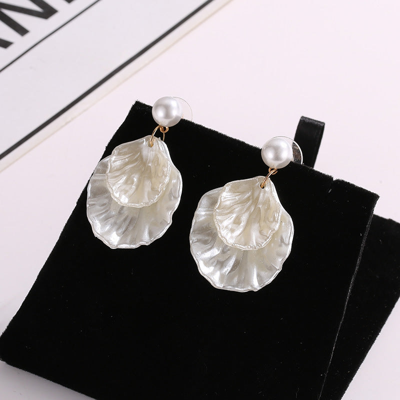 A pair of Maramalive™ Pearl Shell Earrings for Women on a black background.
