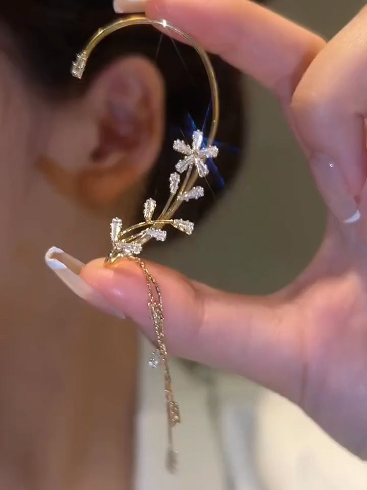 A woman wearing a Tassel Ear Clip - Non-Pierced Women's Fashion from Maramalive™.