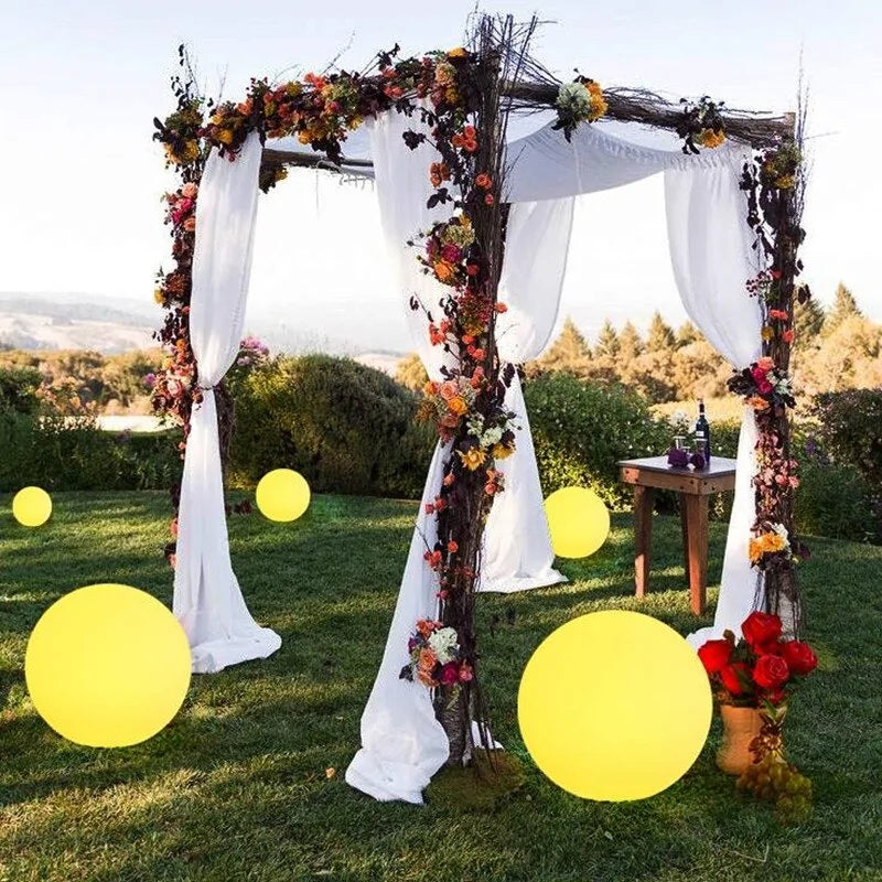 A white Maramalive™ wedding arch decorated with Waterproof Garden Ball LED Lights for Outdoor.