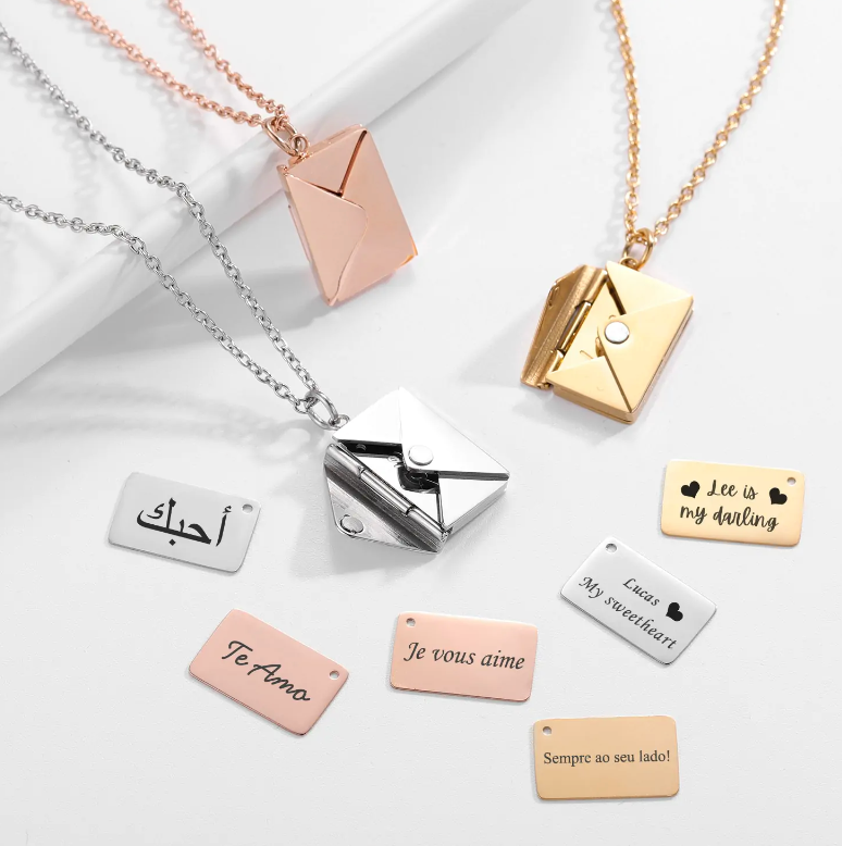 A collection of Maramalive™ Envelope Necklaces with different words on them.