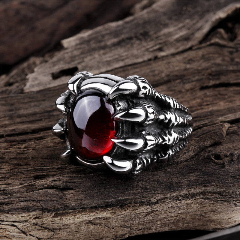 A Personalized Gothic Dragon Claw Men's Ring with claws and a red stone by Maramalive™.