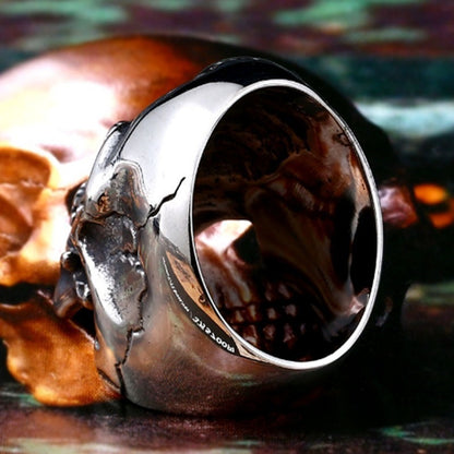 An Express Your Inner Rebel with this Stunning Punk Skull Ring by Maramalive™ on top of a book.