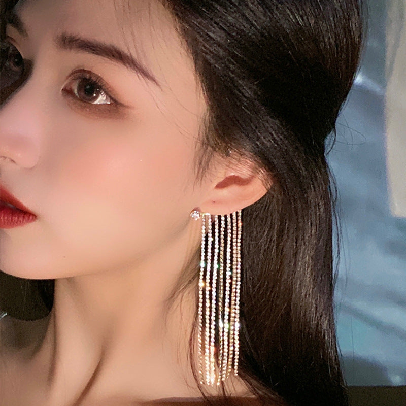 A woman wearing a long tassel earring from Maramalive™.